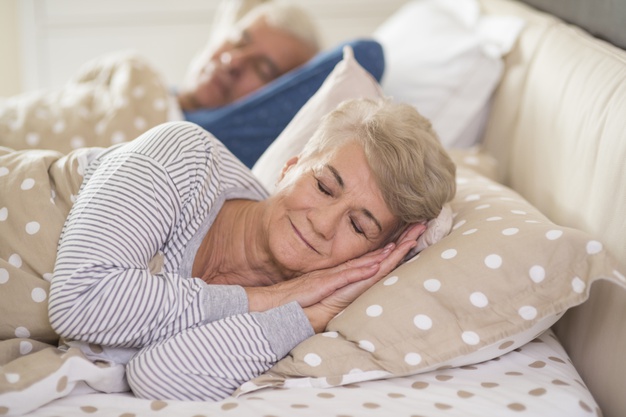 woman-her-husband-sleeping-comfortably_329181-7761